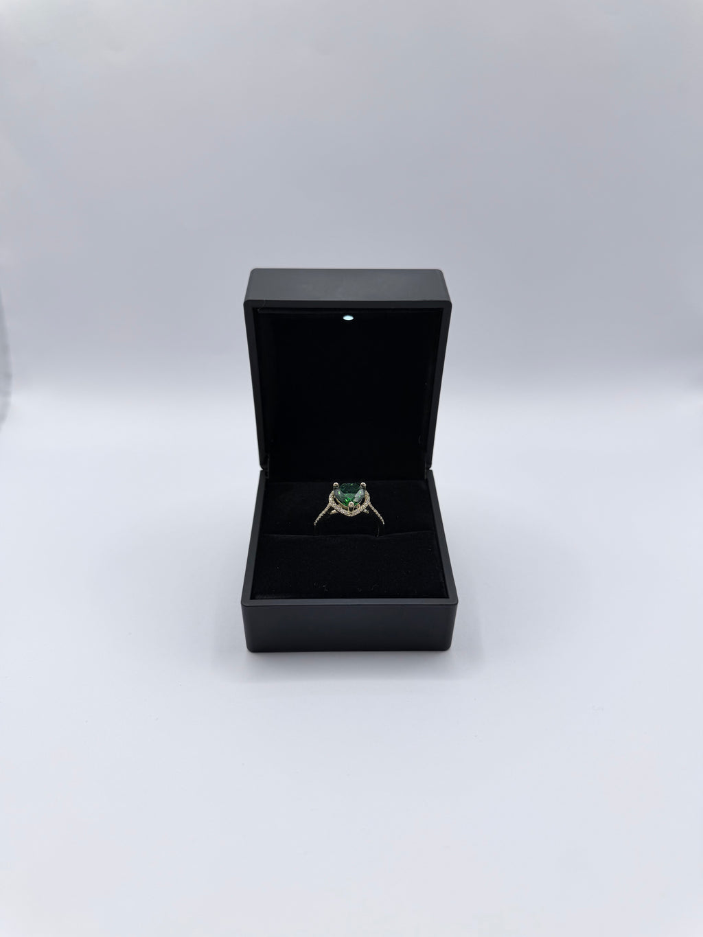 Emerald-colored heart-shaped stone ring