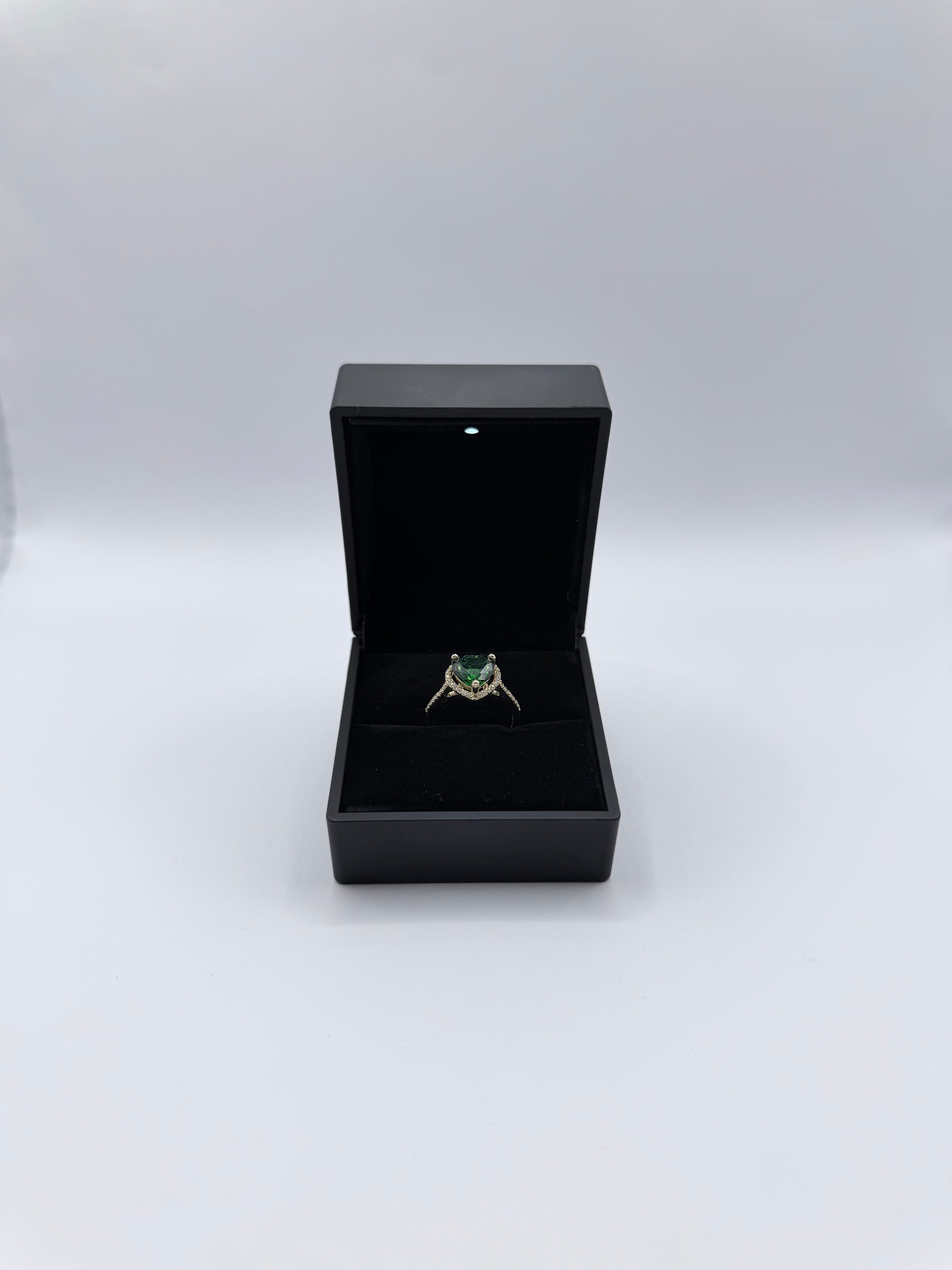 Emerald-colored heart-shaped stone ring