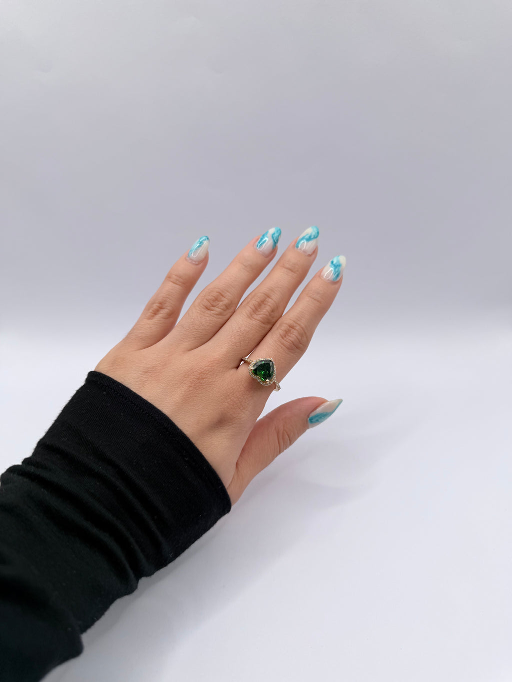 Emerald-colored heart-shaped stone ring