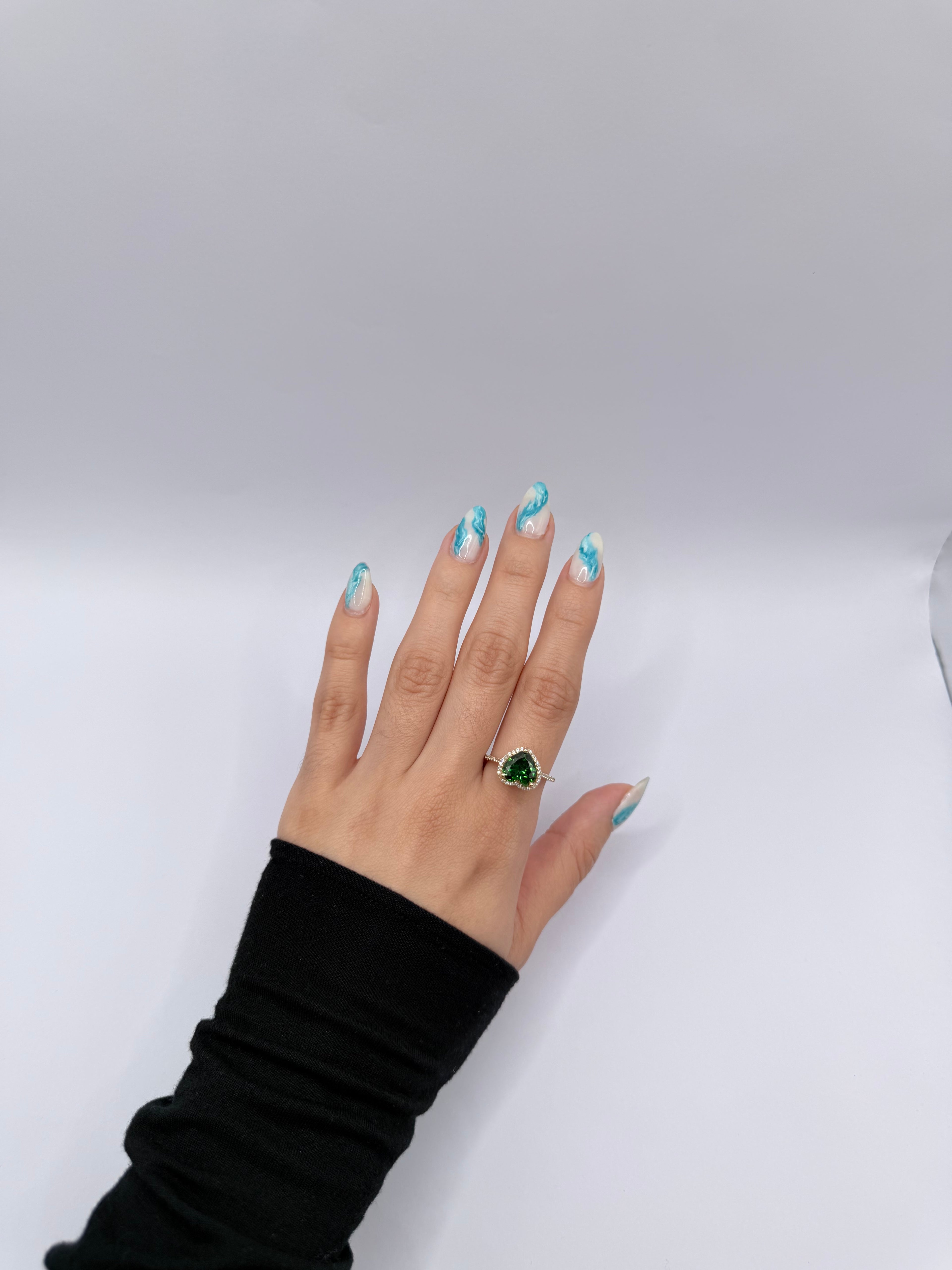 Emerald-colored heart-shaped stone ring