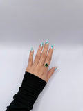 Emerald-colored heart-shaped stone ring