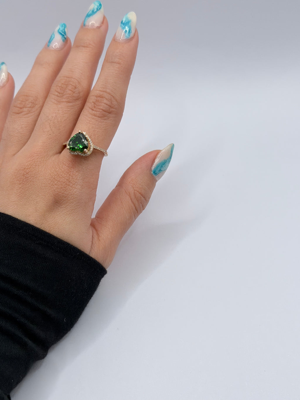 Emerald-colored heart-shaped stone ring