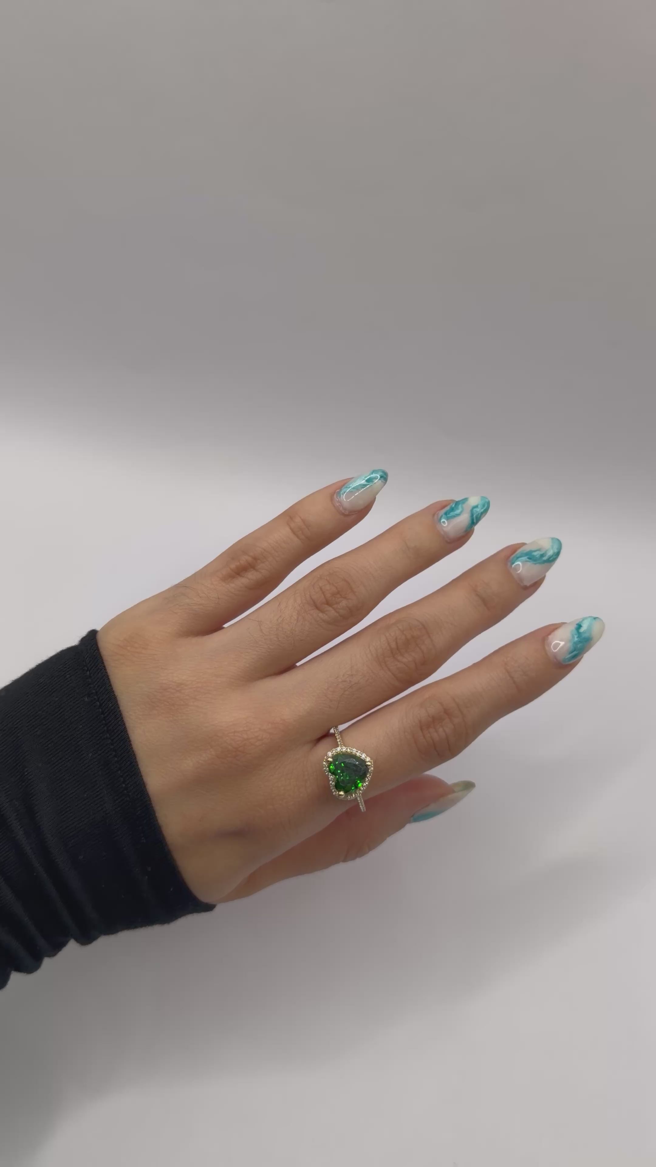 Emerald-colored heart-shaped stone ring